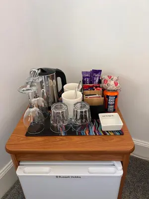 a wooden table with glasses on top of a drawer at Ronebhal Guest House in Oban