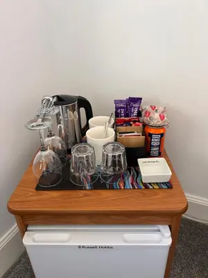 a wooden table with glasses on top of a drawer at Ronebhal Guest House in Oban