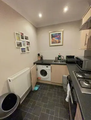 a small kitchen with a sink and a washing machine at Apartment 2 Bed West End in Glasgow