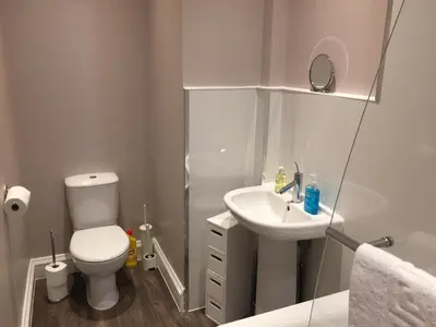 a small bathroom with a toilet and a sink at Apartment 2 Bed West End in Glasgow