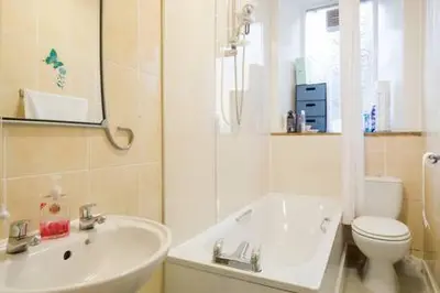 a white bathroom with a sink and a toilet at Watson Crescent in Edinburgh