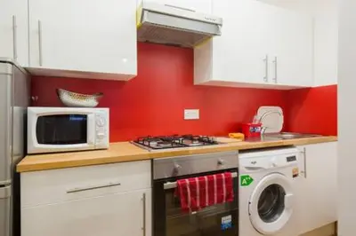 a kitchen with a microwave and a washing machine at Watson Crescent in Edinburgh