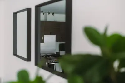 a reflection of a stove in a mirror at SuperbSleep Apartments in Glasgow
