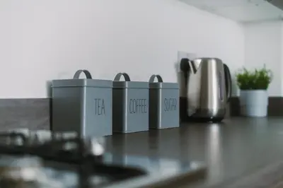 a counter top with four appliances on a table at SuperbSleep Apartments in Glasgow