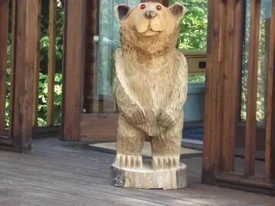 a statue of a bear standing on a stump at Bear Lodge in Auchterarder