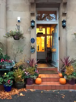 a front door of a house with pumpkins on the steps at Albyn Townhouse in Edinburgh