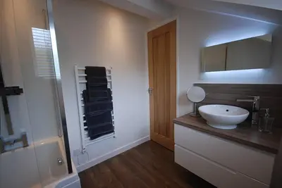 a bathroom with a white sink and a shower at The Beeches at Gleneagles in Auchterarder