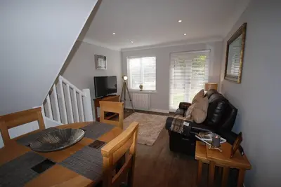 a living room with a couch and a table at The Beeches at Gleneagles in Auchterarder