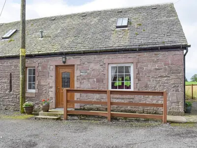 a stone cottage with a window and a wooden fence at The Ploughmans - Uk5531 in Kepculloch