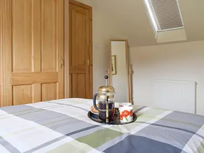 a coffee pot on a plate on a bed at The Ploughmans - Uk5531 in Kepculloch