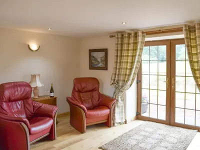 a living room with two chairs and a window at The Ploughmans - Uk5531 in Kepculloch