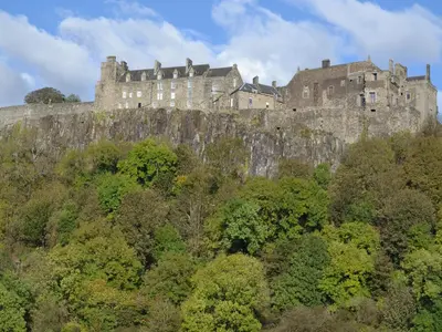 a castle on top of a hill with trees at The Stables - Uk5532 in Kepculloch