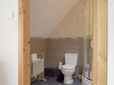 a bathroom with a toilet and a shower at The Stables - Uk5532 in Kepculloch