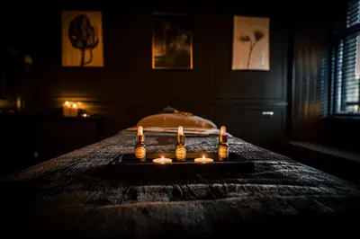 a room with a bed with candles on a table at The Alamo Guest House in Glasgow