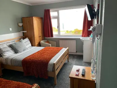 a hotel room with a bed and a window at Greenacre in Oban