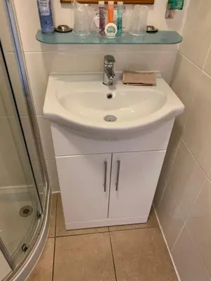 a bathroom with a white sink and a shower at Greenacre in Oban