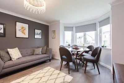 a living room with a couch and a table and chairs at Dunfermline - Luxury Two Bedroom Apartment - TP in Dunfermline