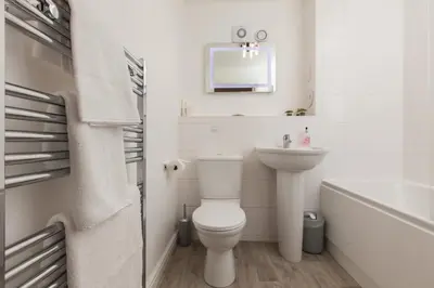 a white bathroom with a toilet and a sink at Dunfermline - Luxury Two Bedroom Apartment - TP in Dunfermline