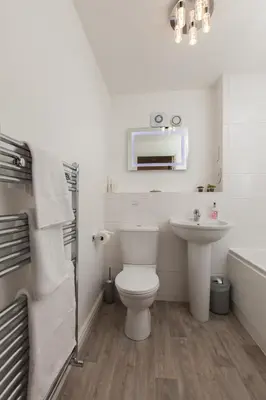a white bathroom with a toilet and a sink at Dunfermline - Luxury Two Bedroom Apartment - TP in Dunfermline