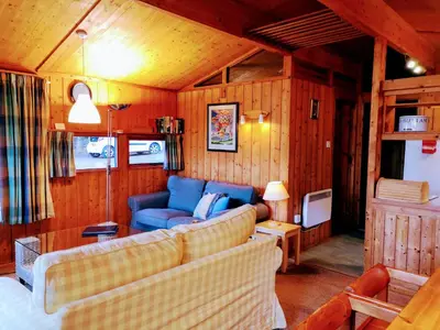 a living room with two couches and a blue couch at Loch Monzievaird Chalets in Crieff