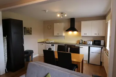a kitchen and dining room with a table and chairs at Blairmains Guest House in Kirk of Shotts