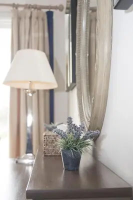 a table with a lamp and a potted plant on it at Bridgend Hotel in Bridgend
