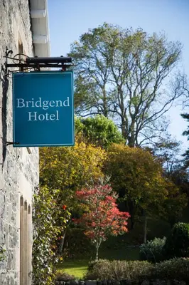 a sign for a hotel on the side of a building at Bridgend Hotel in Bridgend