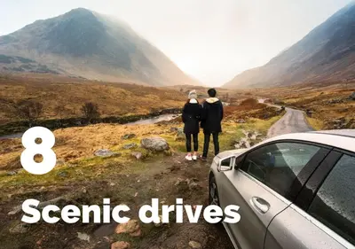 two people standing on a road looking at a car at Ivybank Cottage in Lochgoilhead