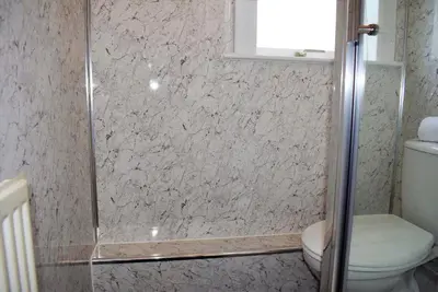 a bathroom with a shower and a toilet at Kelpies Serviced Apartments MacGregor- 2 Bedrooms in Grangemouth