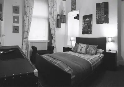a bedroom with a bed and a table with two lamps at Glasgow City Centre Apartment in Glasgow