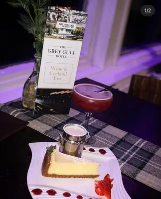 a table topped with a piece of cake on a table at The Grey Gull Hotel in Ardrishaig