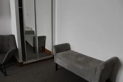 a living room with a couch and a mirror at The Grey Gull Hotel in Ardrishaig