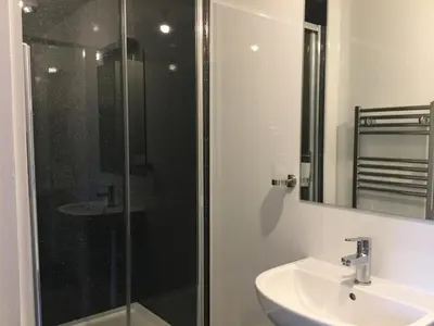 a bathroom with a sink and a shower at Oxgang Kitchen Bar & Rooms in Grangemouth