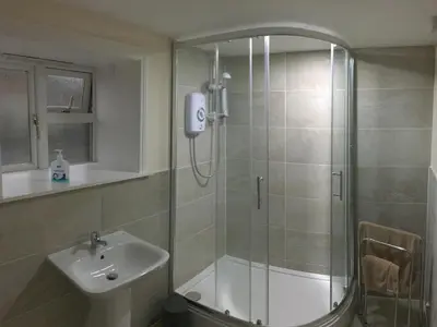 a bathroom with a shower and a sink at The Blackbull Inn Polmont in Polmont