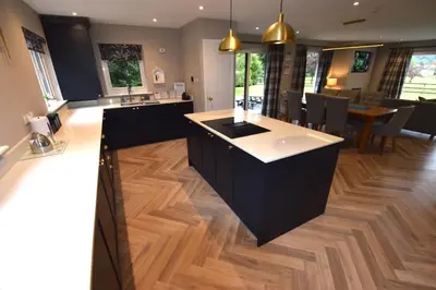 a kitchen with a island in the middle of a room at Crann Mhor Holiday Home in Lochgoilhead