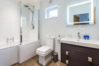 a bathroom with a toilet and a sink and a shower at Auchrannie Resort in Brodick