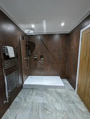 a bathroom with a shower with a glass door at The Scot in Oban