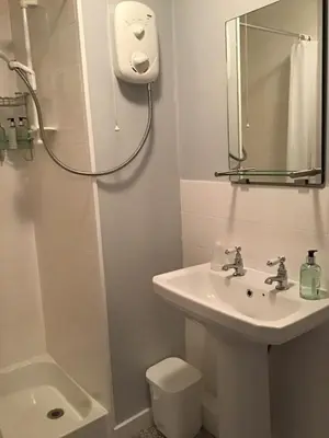 a bathroom with a sink and a toilet and a shower at Comelybank Guesthouse in Crieff