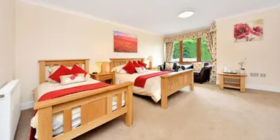 a bedroom with two beds and a living room at Peggyslea Farm B&B in Edinburgh
