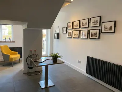 a office with a desk and a yellow chair at The Craigie Hotel in Penicuik