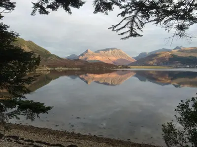 a view of a lake with mountains in the background at The Old Stables, Alltshellach Cottages in North Ballachulish
