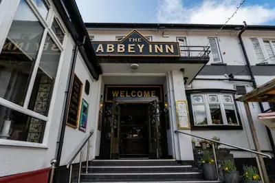 a building with the entrance to the abbey inn at The Abbey Inn in Paisley