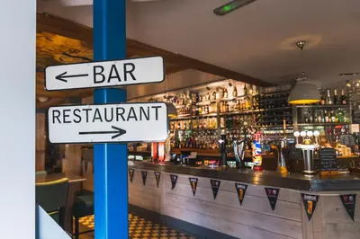a sign that says bar and restaurant in front of a bar at Tullie Inn in Balloch