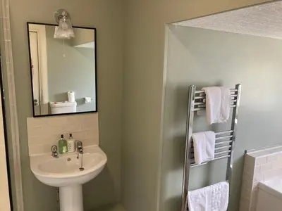 a bathroom with a sink and a mirror at Tullie Inn in Balloch