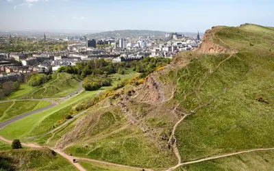 a green hill with a city in the background at Ardleigh House in Edinburgh