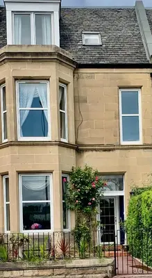 a house with two windows and a fence at Ardleigh House in Edinburgh