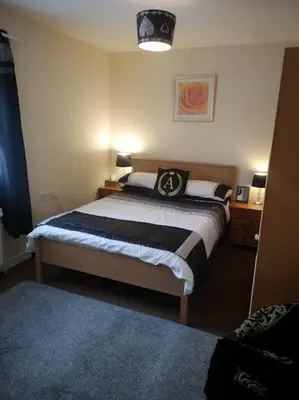 a bedroom with a large bed in a room at Eagles Land in Edinburgh