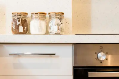 a kitchen with jars on a shelf above a stove at The New Westfield in Edinburgh
