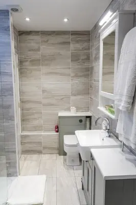 a bathroom with a toilet and a sink and a shower at Quiet Ground Floor Mews Flat and parking in Edinburgh