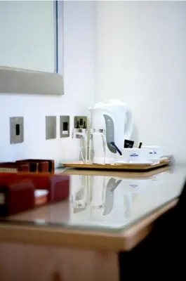 a kitchen counter top with a white appliance on it at Artto Hotel in Glasgow